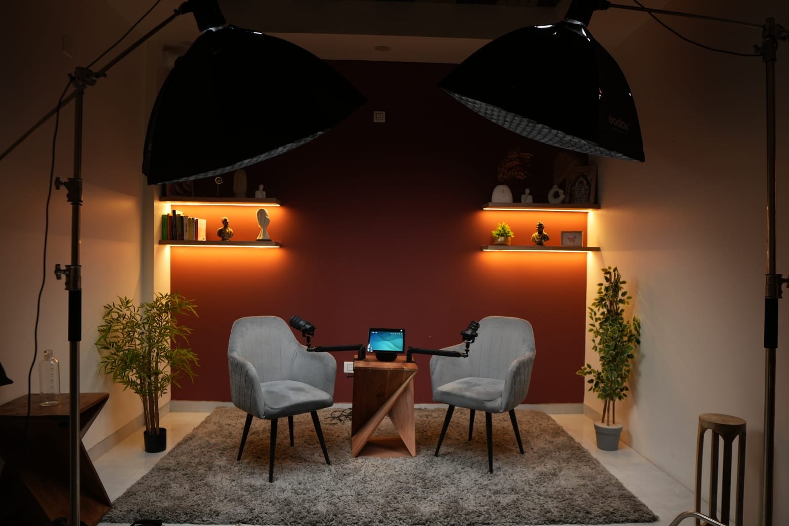 Set Agni – terracotta lounge podcast studio Noida with twin grey chairs